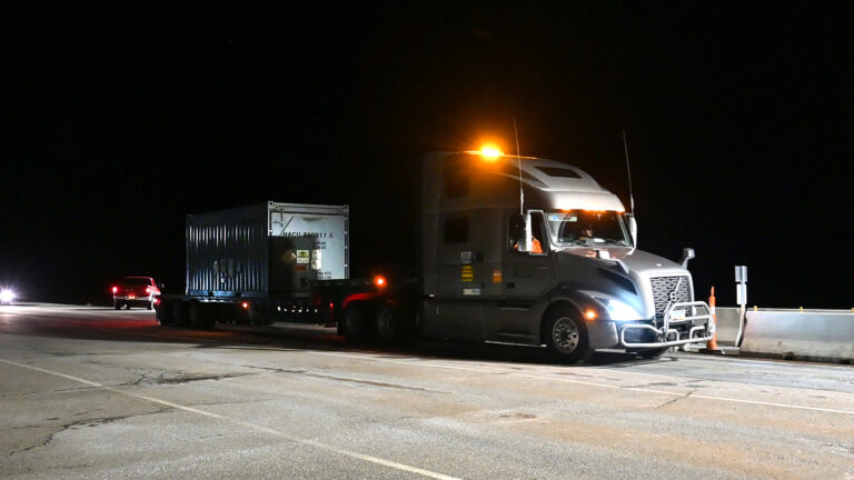 large truck with a metal container on the back